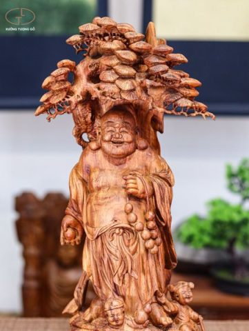 Di lạc đứng dưới gốc cây tùng gỗ sưa
