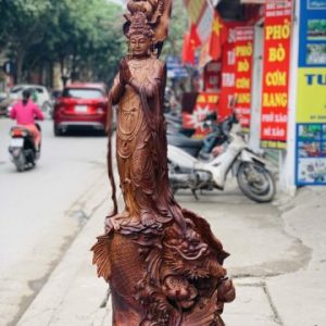 Quan Âm ngự cá chép hóa rồng gỗ cẩm. Quan Âm ngự cá chép hóa rồng gỗ cẩm.