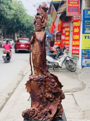 Quan Âm ngự cá chép hóa rồng gỗ cẩm. Quan Âm ngự cá chép hóa rồng gỗ cẩm.