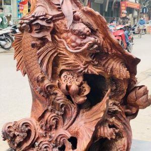 Quan Âm ngự cá chép hóa rồng gỗ cẩm. Quan Âm ngự cá chép hóa rồng gỗ cẩm.