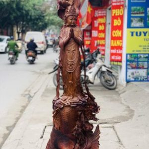 Quan Âm ngự cá chép hóa rồng gỗ cẩm. Quan Âm ngự cá chép hóa rồng gỗ cẩm.